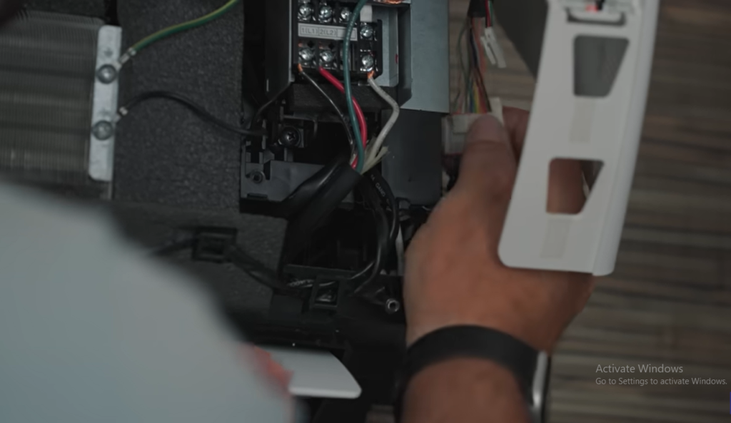HVAC technician inspecting a ductless mini split AC system