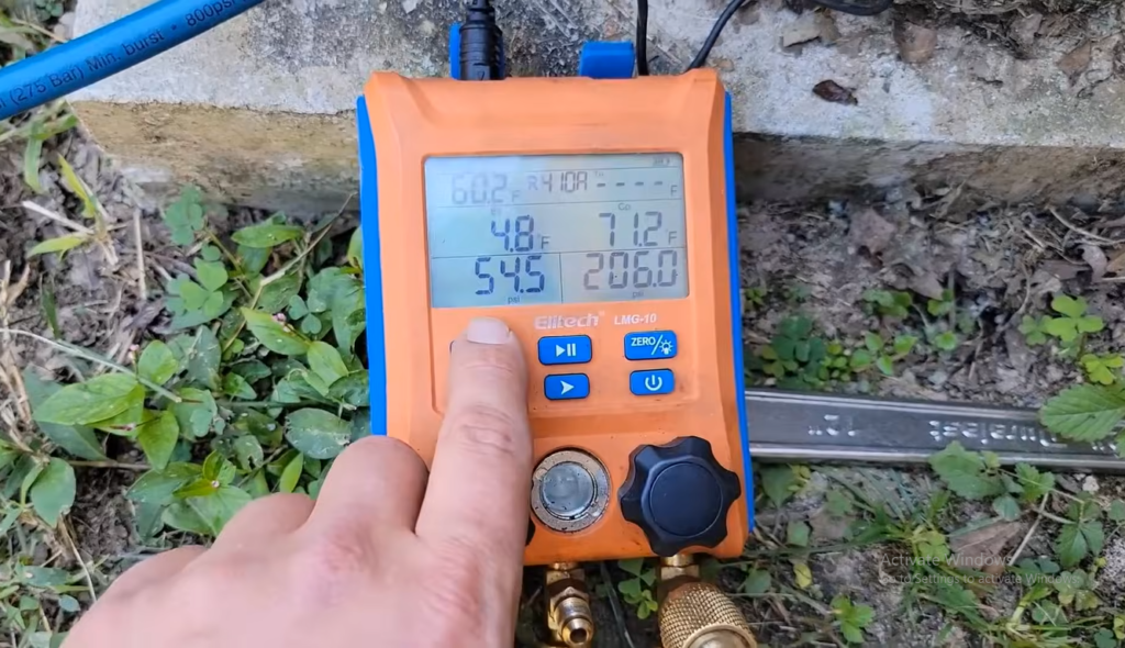 Technician inspecting a wall-mounted mini split air conditioner to diagnose low refrigerant levels