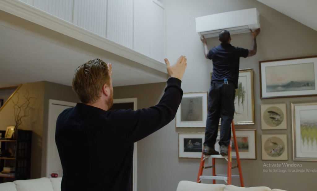 Technician installing ductless mini split system in home without ducts