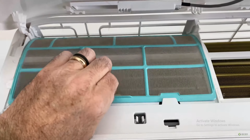 Removing mini split AC filters gently for cleaning